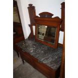 A MARBLE TOPPED OAK DRESSING TABLE WITH CARVED DETAIL. MIRROR NOT ATTACHED AND MISSING TILED BACK