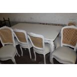 A WHITE PAINTED DINING ROOM TABLE AND SIX CHAIRS