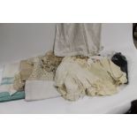 A QUANTITY OF VINTAGE LINEN AND CHILDREN'S CLOTHES, to include christening gowns, knitted cot