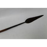 AN ANTIQUE AFRICAN STABBING SPEAR, with leaf shaped blade and engraved decoration on brass