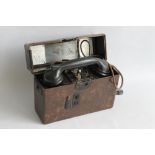 A WWII ERA GERMAN M33 TYPE FIELD TELEPHONE, with brown Bakelite case, handset marked 1939.