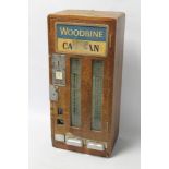 A WALL MOUNTED "WOODBINE" CIGARETTE VENDING MACHINE, wood cased 30 cm x 66 cm with keys