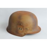 A WWII GERMAN HELMET with a worn SS type decal to side, impressed number to inside '538' rusted