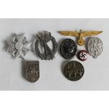 A THIRD REICH 'TAG DER ARBEL II' DAY BADGE, a black wound badge and six other assorted German