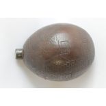 AN EARLY 19TH CENTURY BUGBEAR COCONUT POWDER FLASK, carved with the badge and battle honours of