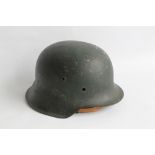 A WWII GERMAN HELMET, worn decal to side, impressed number, appears to read D 3260, with detached