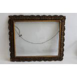 AN ANTIQUE GILT PICTURE FRAME WITH GLASS