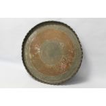 A LARGE INDO-PERSIAN COPPER ALLOY TRAY, with hand etched engraving and a raised pie crust rim.