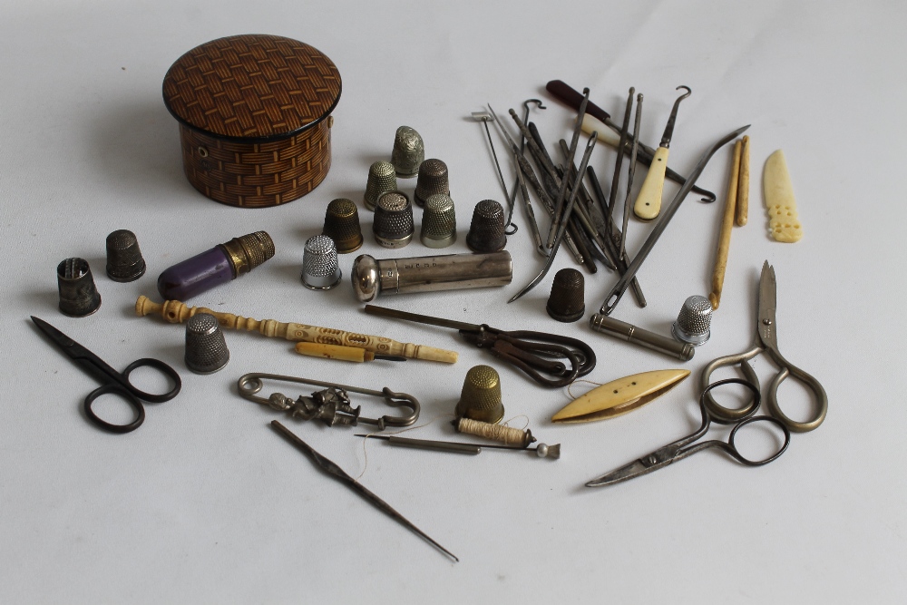 A COLLECTION OF SEWING ACCESSORIES to include thimbles, scissors etc. and a silver needle case