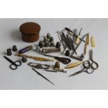 A COLLECTION OF SEWING ACCESSORIES to include thimbles, scissors etc. and a silver needle case