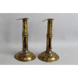 A PAIR OF 18th CENTURY BRASS CANDLESTICKS, with side ejectors. Height 17 cm.