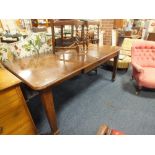 AN ANTIQUE OAK LARGE DINING TABLE