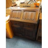 AN OAK LINENFOLD BUREAU