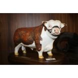 A DON FINE ART STUDIO MATTE FINISH CERAMIC HEREFORD BULL FIGURE ON PLINTH