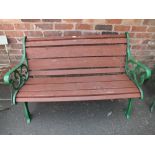 A GARDEN BENCH WITH CAST GREEN LEGS