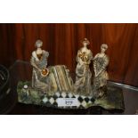 AN UNUSUAL GLAZED CERAMIC FIGURE GROUP - INITIALS TO BASE