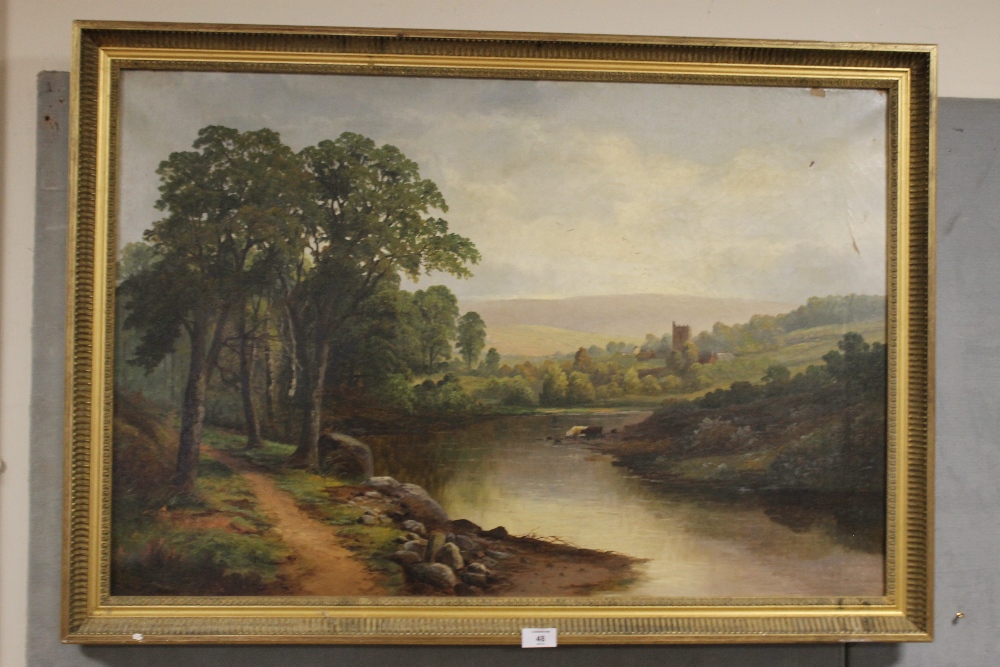 G. BATES. A wooded river landscape with cattle watering, village and hills beyond 'Brecon Church