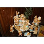 A PENDELFIN RABBIT DISPLAY STAND WITH FIGURES (14)