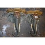 A PAIR OF MODERN RESIN WALL MOUNTABLE ELEPHANT BUST SHELVES