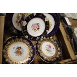 A TRAY OF GILDED NAVY BLUE FLORAL PLATES TO INCLUDE A PAIR SIGNED L MONET, ROYAL CROWN DERBY ETC