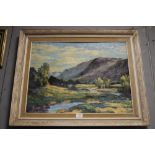 A LARGE FRAMED OIL ON BOARD MOUNTAINOUS RIVER SCENE SIGNED WHITWELL