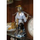 AN ORIENTAL STYLE CERAMIC WATER CARRIER FIGURE