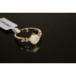 A MODERN 10K GOLD OPAL SET DRESS RING