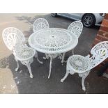 A CIRCULAR CAST GARDEN TABLE WITH FOUR CHAIRS