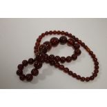 A VINTAGE CHERRY AMBER STYLE NECKLACE