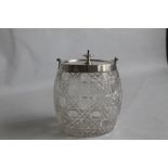 A CUT GLASS BISCUIT BARREL, with hallmarked silver lid and swing handle