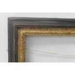 AN ANTIQUE PICTURE FRAME WITH GLASS AND DECORATIVE GILT APERTURE, frame size approx. 65 cm x 51 cm