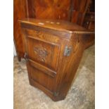 A SMALL OAK CORNER CUPBOARD WITH CARVED TUDOR ROSE