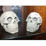 A PAIR OF SMALL MODERN STONEWARE SKULLS WITH CELTIC STYLE DECORATION