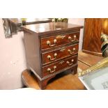 A SMALL 19TH CENTURY MAHOGANY CHEST OF THREE DRAWERS, with brass swan neck handles, raised on