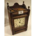 AN ANTIQUE OAK CARVED MANTLE CLOCK