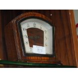 AN ART DECO OAK DOMED MANTEL CLOCK