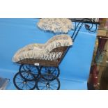 A SMALL DOLLS PRAM WITH PARASOL