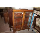 AN OAK JACOBEAN STYLE DISPLAY CABINET