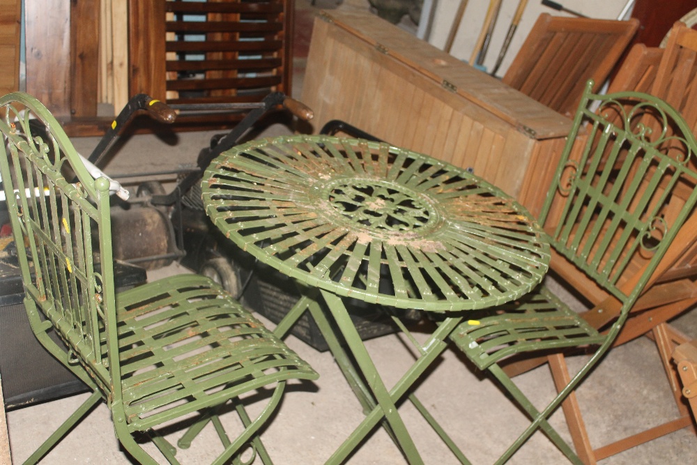 A CAST PATIO TABLE AND TWO CHAIRS