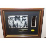 A FRAMED AND GLAZED LIMITED EDITION FILM CELL OF JOHN WAYNE