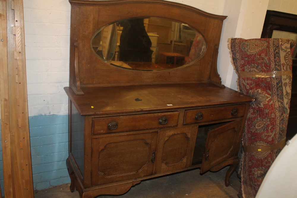 AN OAK MIRROR BACKED SIDEBOARD