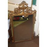 A LARGE DECORATIVE GILT MIRROR