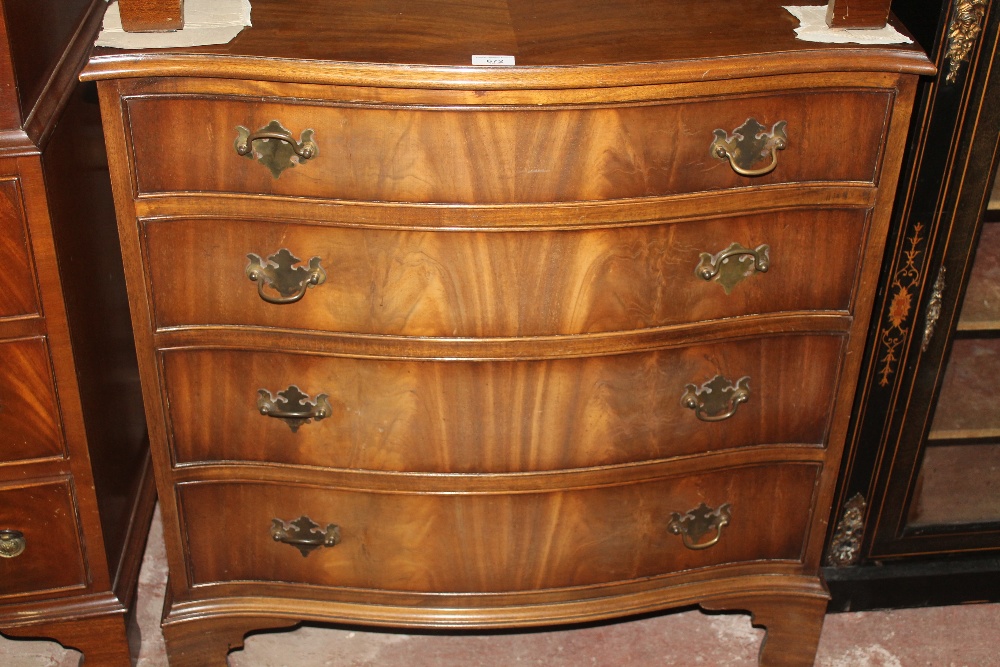 A MAHOGANY SERPENTINE CHEST OF DRAWERS