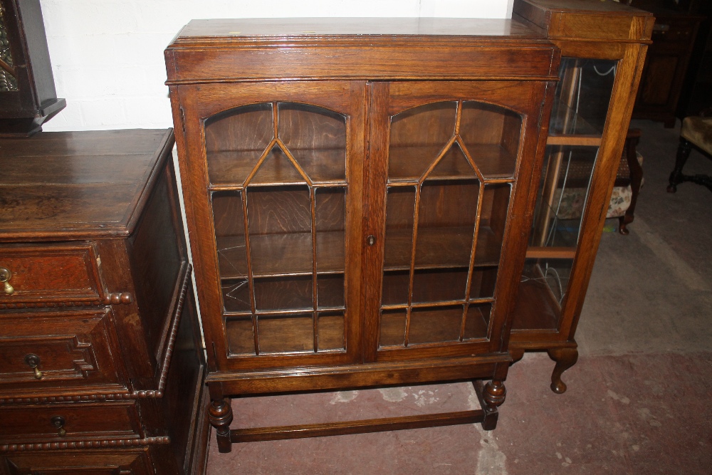 AN OAK GLAZED CHINA DISPLAY CABINET