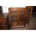 AN OAK GLAZED CHINA DISPLAY CABINET