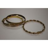 A HALLMARKED 9 CARAT GOLD TWIST BAND BANGLE, approx weight 5.8g, together two other bangles (3)