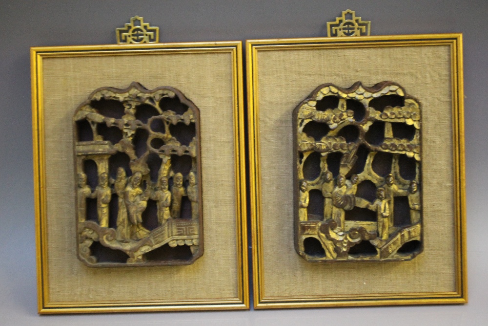 TWO FRAMED ORIENTAL CARVED WOODEN PLAQUES, gilt relief figural images, red background, 21 x 14.3