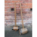 A VINTAGE METAL BANDED LARGE WOODEN MALLET, overall H 95 cm, together with a smaller example (2)