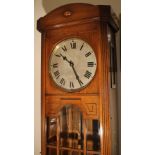 AN EARLY 20TH CENTURY OAK GLAZED LONGCASE CLOCK, the silvered dial with Roman numerals, the case