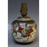 AN ORIENTAL CERAMIC LAMP BASE DECORATED WITH BATTLE SCENES, H 20 cm, W 13 cm